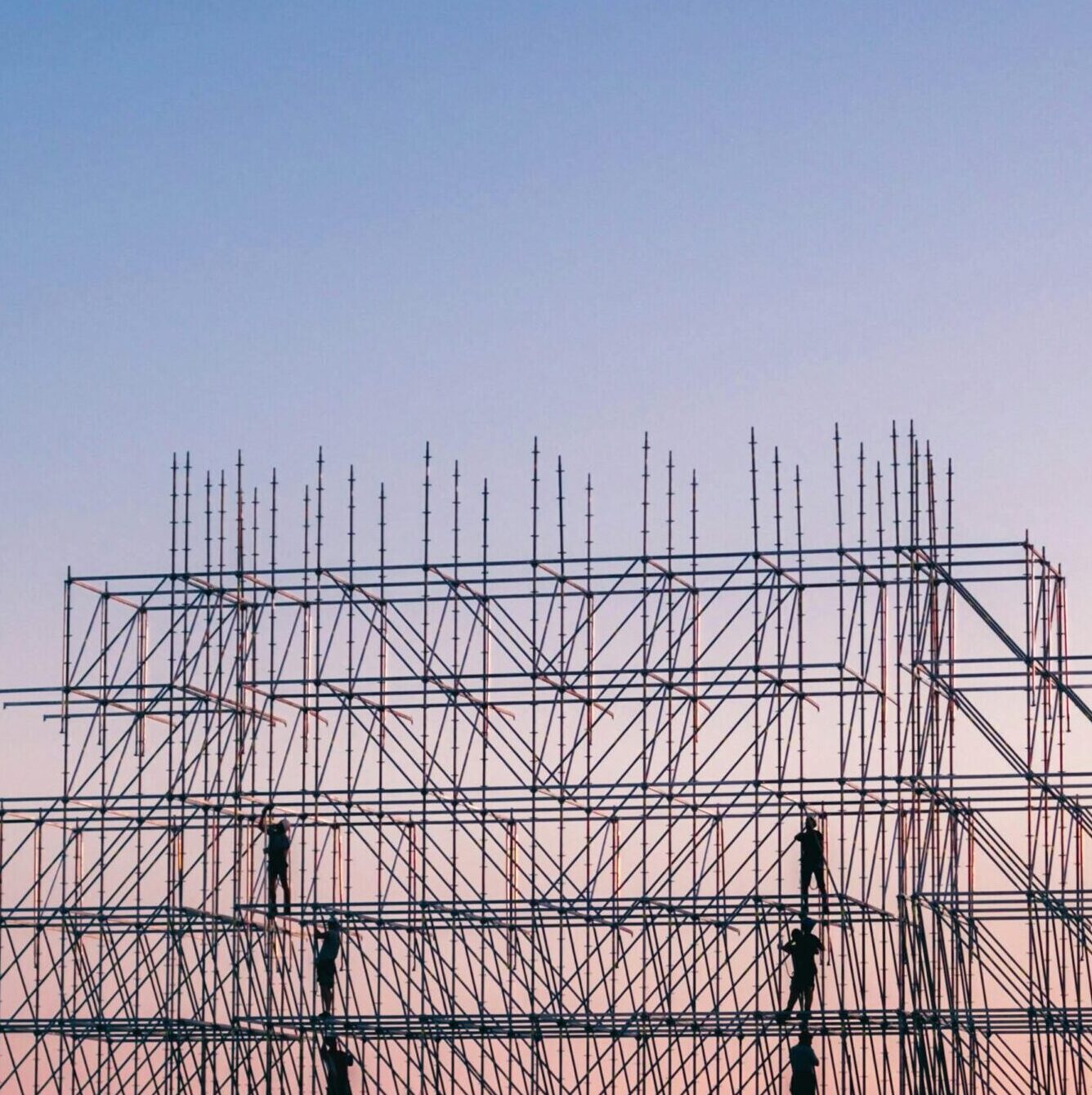 A silhouetted structure against a colorful sunset, showcasing industrial scaffolding in Sochi, Russia.